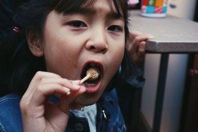 Portrait of cute girl eating food