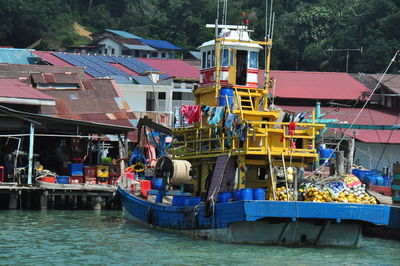 People in boat against buildings