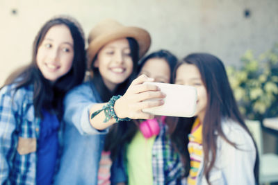 Portrait of smiling young woman using mobile phone