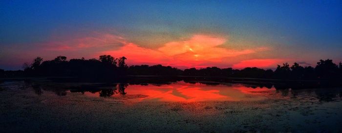 Scenic view of lake at sunset