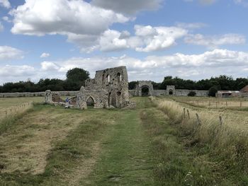 Old ruins on field against sky