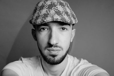 Portrait of young man against wall