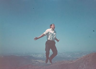 Full length of smiling man standing on beach
