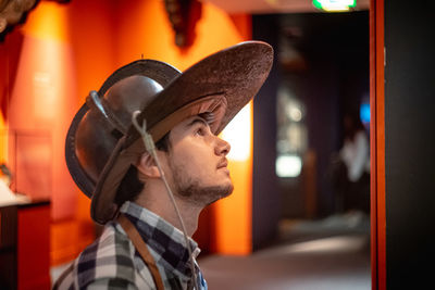 Side view of man wearing firefighters helmet