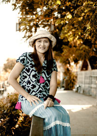 Portrait of smiling young woman in park