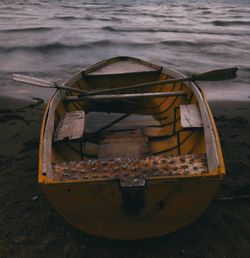 Close-up of boat moored on beach