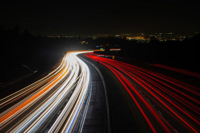 High angle view of light trails on highway at night