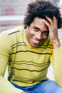 Portrait of smiling man sitting outdoors