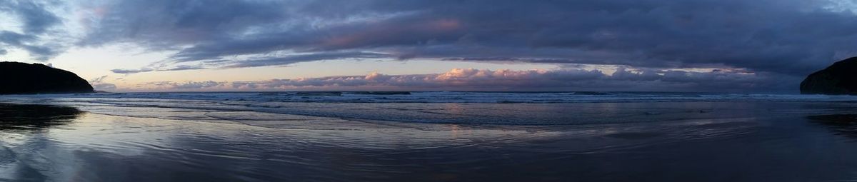 Panoramic view of beach against sky during sunset