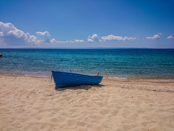 Scenic view of beach against blue sky