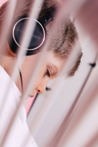 Side view of thoughtful boy wearing headphones