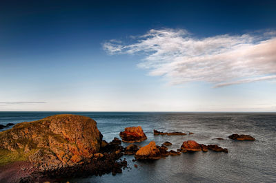 Scenic view of sea and rocks against sky