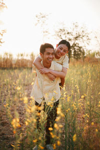 Portrait of smiling young woman standing on field