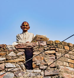 Low angle view of man against built structure