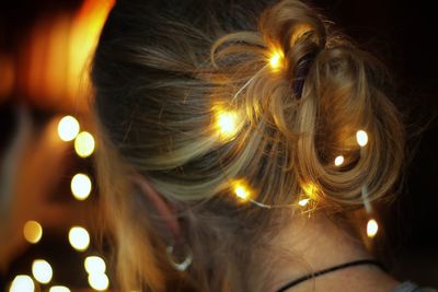 Close-up portrait of woman with illuminated light painting at night