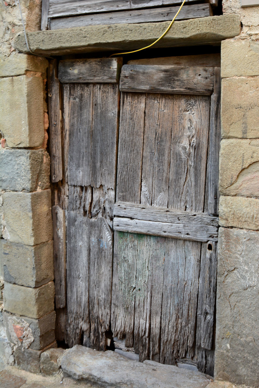 architecture, built structure, door, entrance, building exterior, wood, wall, closed, building, no people, old, house, wall - building feature, day, ancient history, security, protection, history, weathered, outdoors, residential district, the past, iron, window, doorway, abandoned