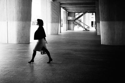 Full length of woman standing by railing