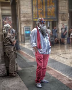 Full length of woman standing on railing
