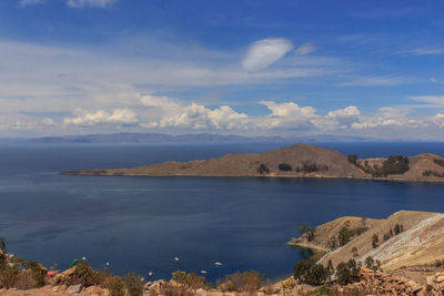 Scenic view of sea and mountains against sky