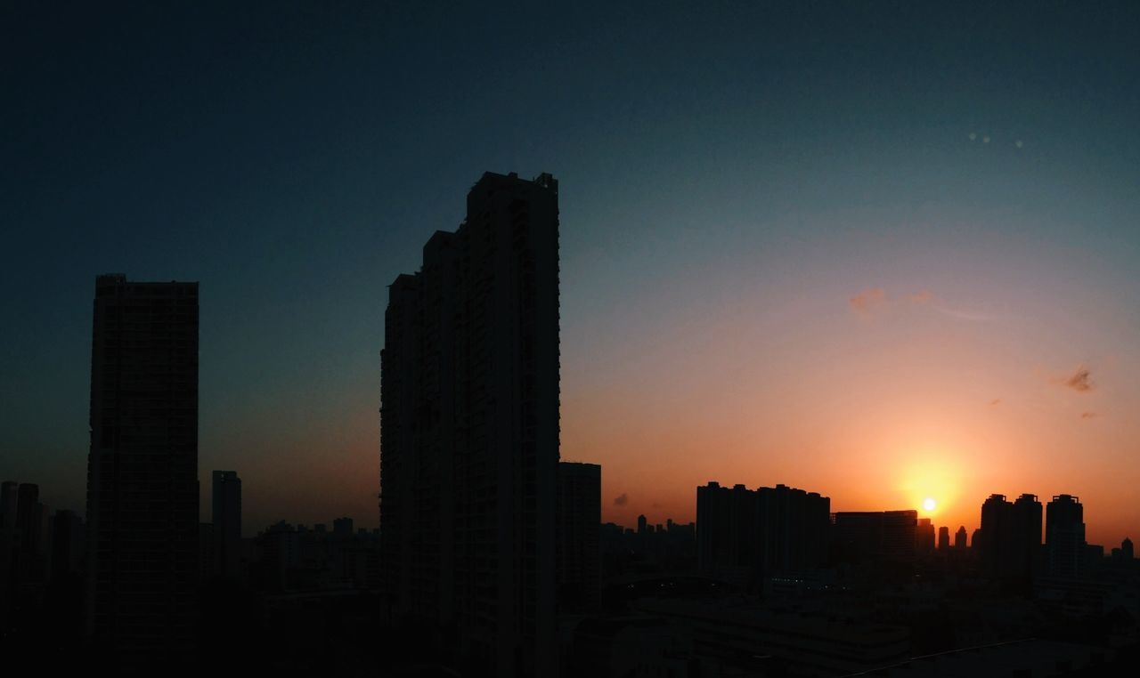 sunset, building exterior, architecture, built structure, silhouette, city, skyscraper, sun, cityscape, urban skyline, orange color, sky, sunlight, tall - high, building, skyline, tower, office building, dark, outdoors