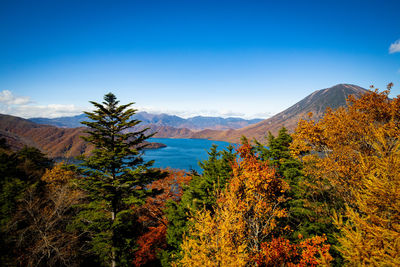 Scenic view of mountains against blue sky