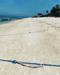 Scenic view of beach against blue sky