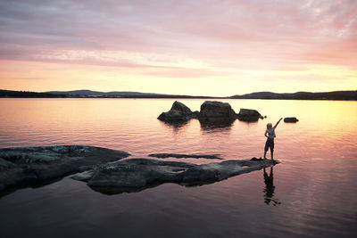 Girl at lake at sunset, siljan, dalarna, sweden