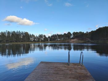 Scenic view of swimming pool by lake against sky