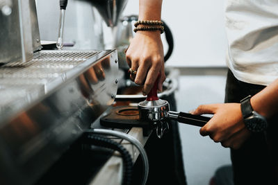 Midsection of man working with coffee