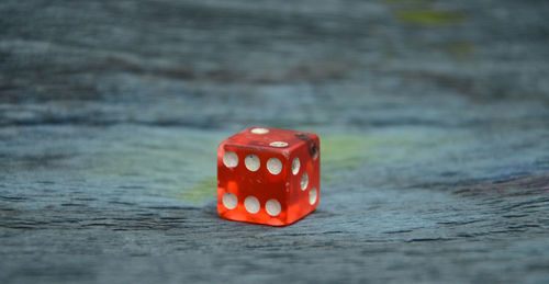 Close-up of red dice on wooden table