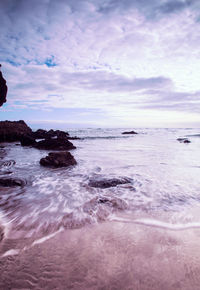 View of calm sea against cloudy sky