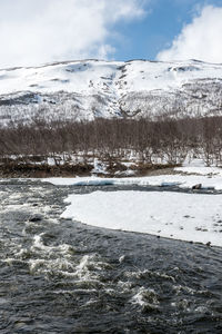 Scenic view of lake against sky during winter