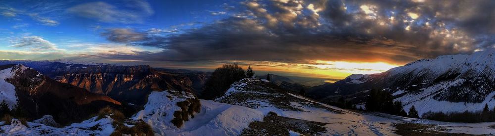 Scenic view of snowcapped mountains against sky during sunset