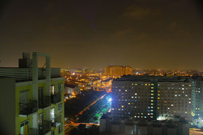 High angle view of city lit up at night