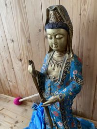 Close-up of buddha statue against wall