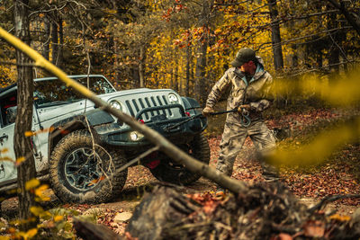 Rear view of man sitting in forest