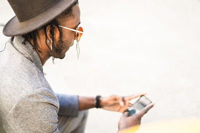 Side view of man using mobile phone