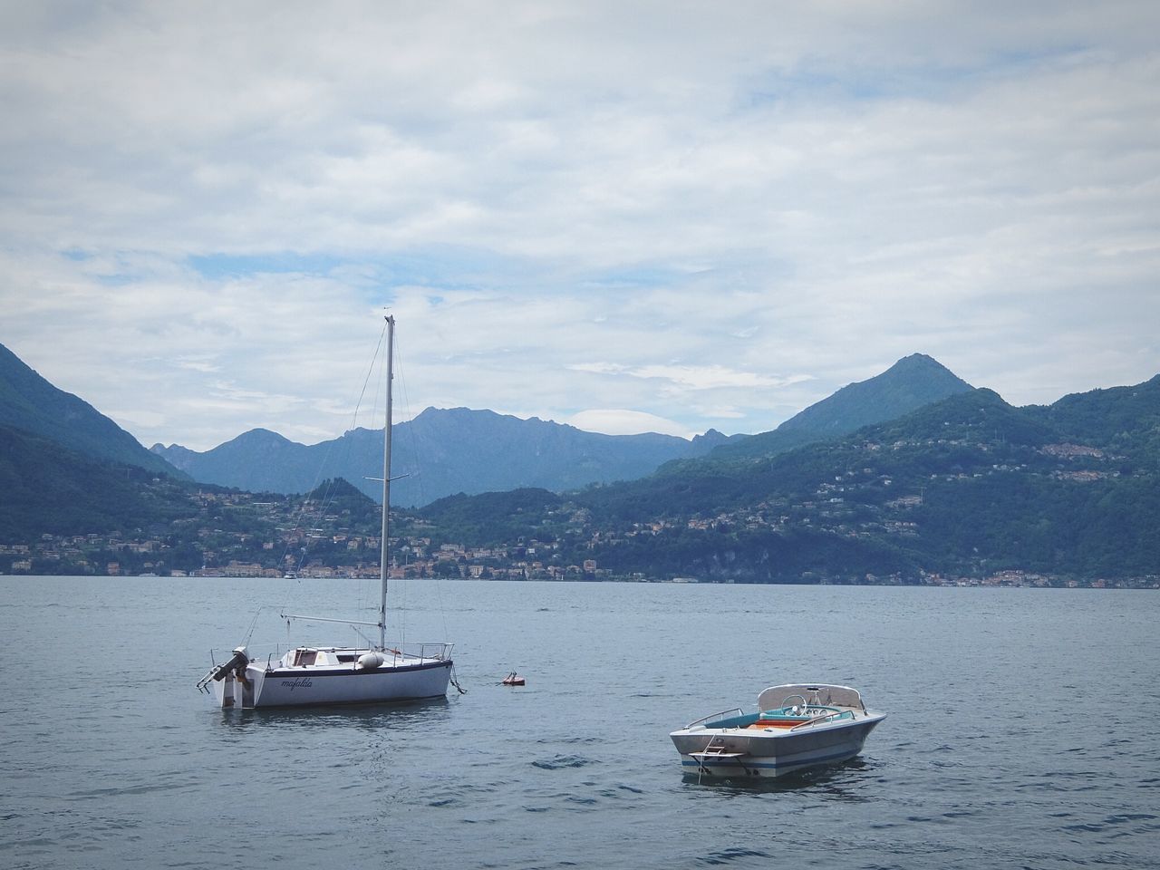 mountain, nautical vessel, transportation, water, boat, mode of transport, mountain range, waterfront, sky, scenics, tranquil scene, tranquility, beauty in nature, nature, sailing, cloud - sky, sea, lake, moored, river