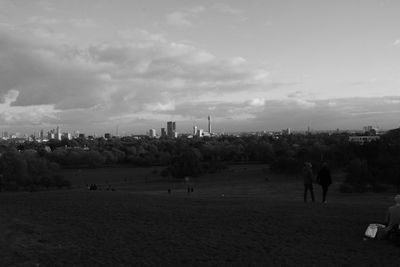 People in city against sky