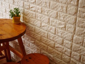 High angle view of potted plants on table against wall