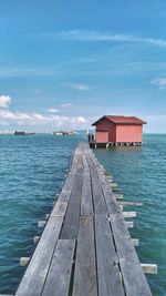 Pier over sea against sky