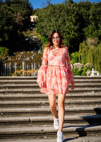 Full length of woman moving down on staircase