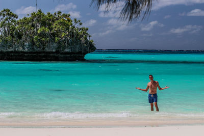 Man on beach against blue sky