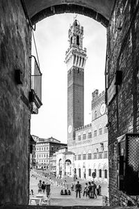 People in historic building against sky