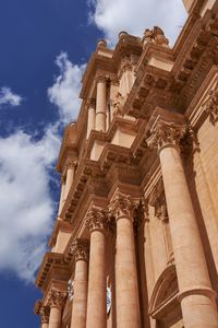 Low angle view of historical building against cloudy sky