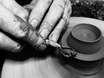 Cropped hands of person making pottery