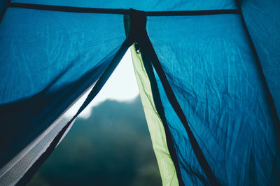 Low angle view of sky seen through open zipper of tent