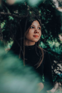 Portrait of young woman in forest