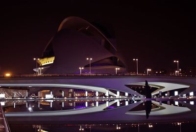 Illuminated bridge against sky at night