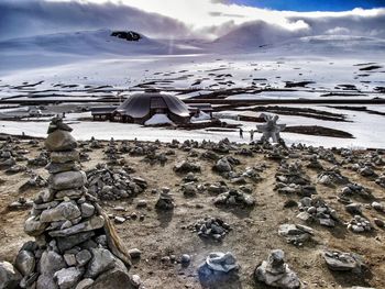 Scenic view of snow covered land against sky